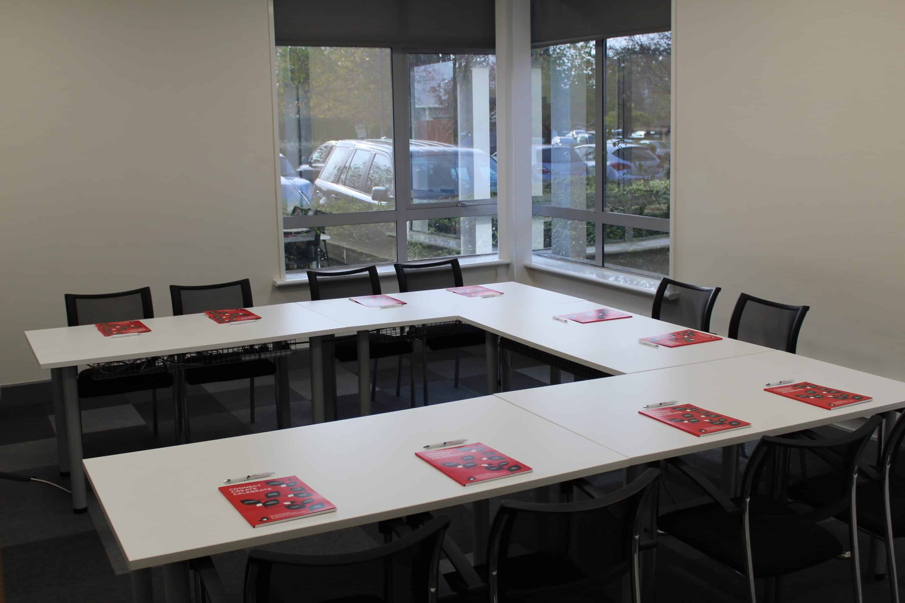two men in building yard with hard hats, shaking hands