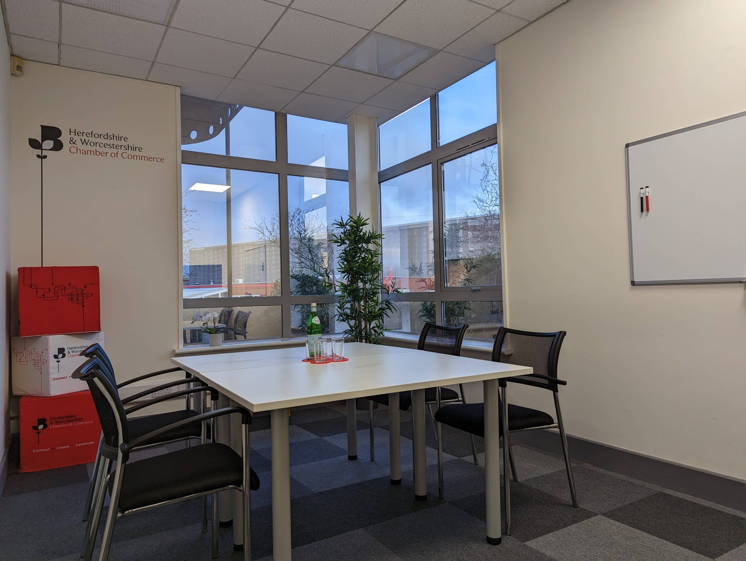 two men in building yard with hard hats, shaking hands