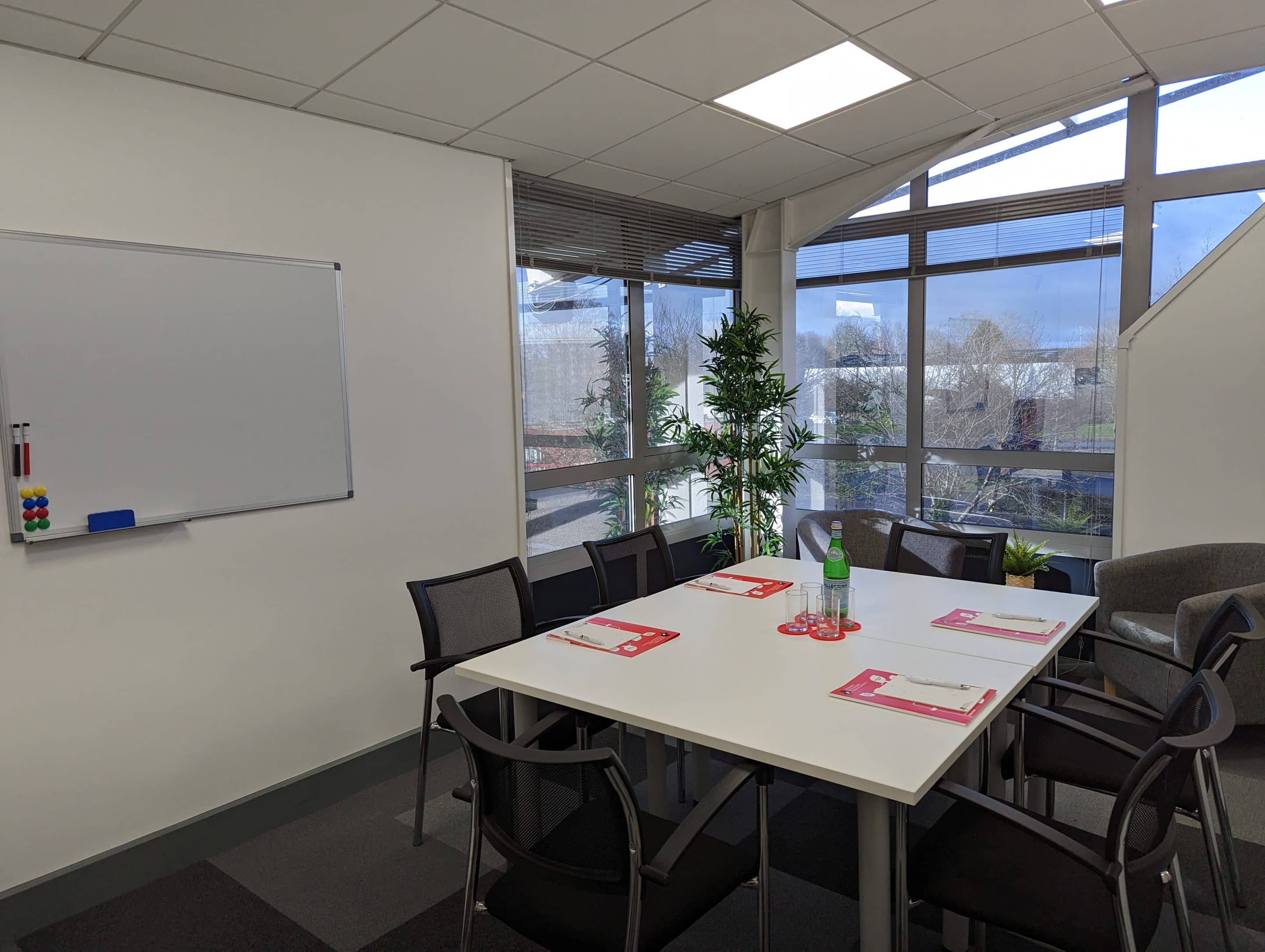 two men in building yard with hard hats, shaking hands